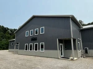 Metal commercial building with HVAC system installation on exterior